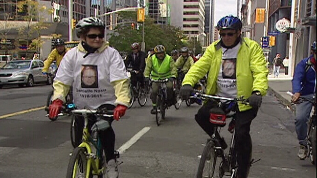 Cyclists participate in a memorial ride for Danielle Nacu through downtown Ottawa Thursday, Oct. 11, 2012.