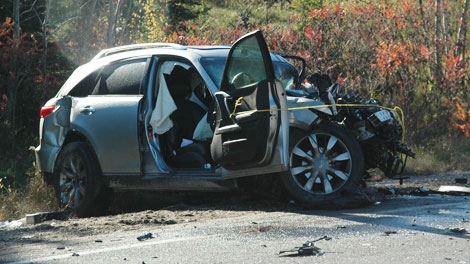 The front of an SUV is crumpled after a head-on collision on Highway 17, west of Ottawa, Thursday, Oct. 7, 2010.
