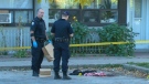 Police investigate the scene outside of a Regent Park apartment building, where two men were shot early Saturday, Oct. 9, 2010.