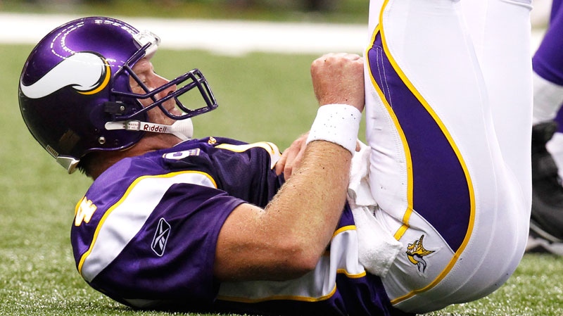 Minnesota Vikings quarterback Brett Favre grimaces after being knocked to the turf by a New Orleans Saints pass rush in the first half of their NFL football game in New Orleans, Thursday, Sept. 9, 2010. (AP / Gerald Herbert)