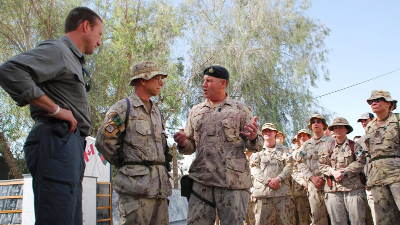 Defence Minister Peter MacKay (left) and Chief of Defence Staff Walter Natynczyk (centre) talk to Canadian soldiers in Kandahar, Afghanistan, Sunday, Oct.10, 2010. (Jonathan Montpetit / THE CANADIAN PRESS)