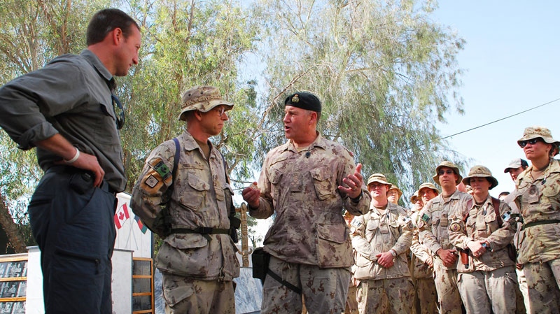 Defence Minister Peter MacKay, left, and Chief of Defence Staff Walter Natynczyk, centre, talk to Canadian soldiers in Kandahar, Afghanistan, Sunday, Oct. 10, 2010. (Jonathan Montpetit / THE CANADIAN PRESS)