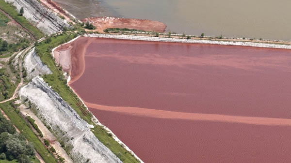 A picture taken in June 2010 by Hungarian air photo company Interspect and made available Tuesday, Oct. 12 2010 shows the dam of the reservoir in Kolontar, Hungary, with red stains that allegedly indicate red sludge leaking through, nearly four months before the wall broke. (AP /Interspect / Bako Gabor)