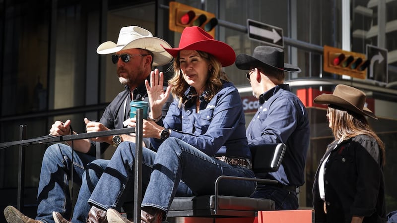 'You suuuuuck!': Smith gets cheers and jeers riding in Calgary Stampede parade