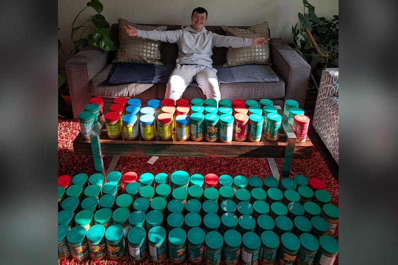 Young volunteer with Down syndrome collecting peanut butter for food-insecure children in Ontario's Waterloo Region