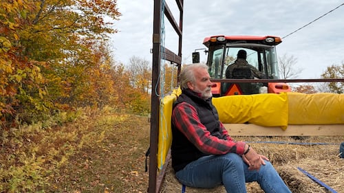 A man sits in a tractor.