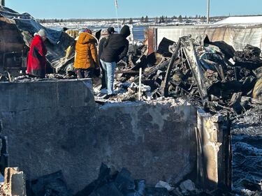 Employees check out the remains of a lobster processing plant in Wallace, N.S., after a fire on Dec. 8, 2025. (CTV Atlantic / Jonathan MacInnis)