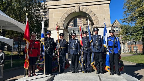 Officers stand at a memorial service.