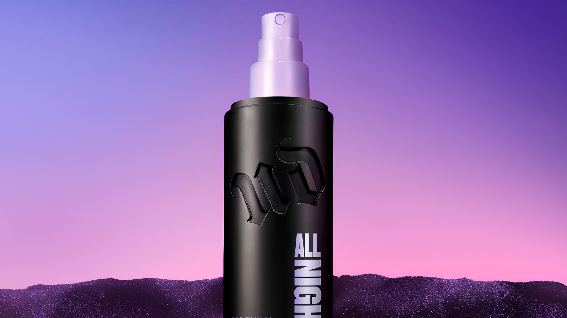 A bottle of Urban Decay setting spray on a gradient background.