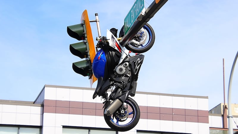Motorcycle left dangling from traffic light pole after B.C. crash