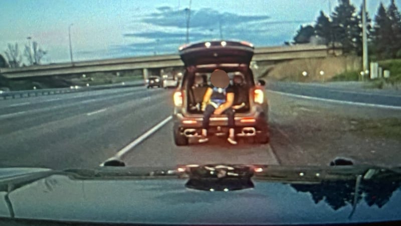 Passenger spotted sitting in open trunk of SUV, filming 2 sports cars on Ottawa highway