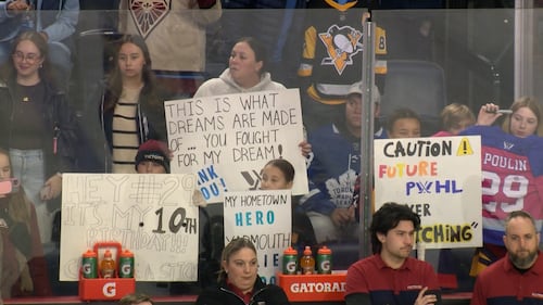 Fans hold up signs at a PWHL Takeover Tour game in Halifax between Montreal Victory and the Toronto Sceptres on Dec. 17, 2025. (CTV Atlantic / Jim Kvammen)