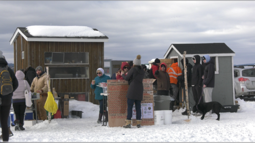 People are pictured lining up for food, drinks and prize draws during the annual Family Day ice fishing event at Dominion Park in Saint John, N.B. (Avery MacRae / CTV Atlantic)