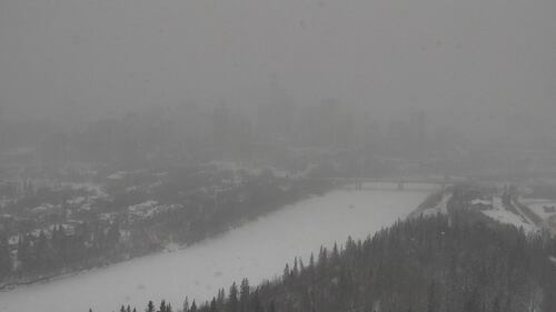 Snow obscures an aerial view of downtown Edmonton and the North Saskatchewan River during a storm on Feb. 17, 2026. (CTV News Edmonton)