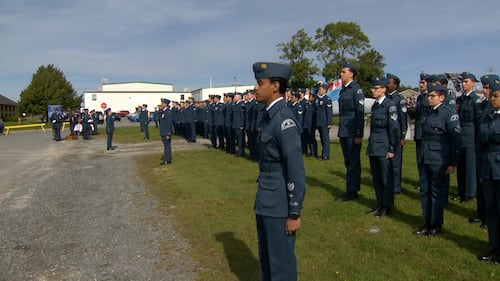 Members of the military stand in a line.