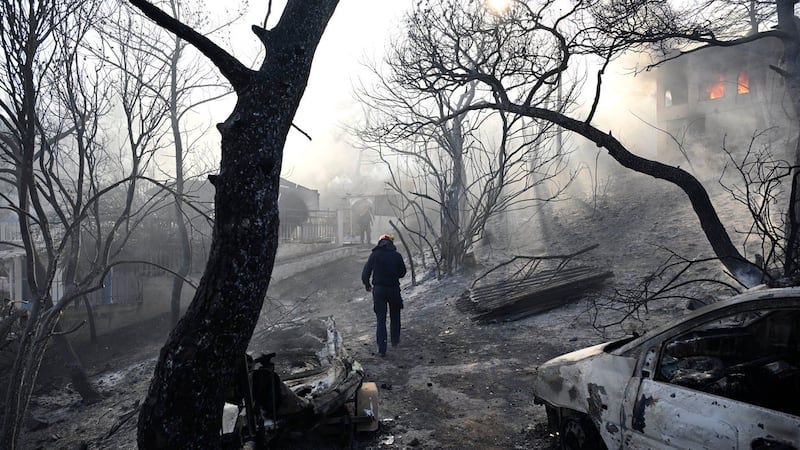 Firefighters battle massive wildfires in Belgium and Greece as 2 die on an island near Athens