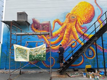 An artist works on a mural of an octopus as part of the Halifax Mural Festival 2026. (CTV/Mike Lamb)