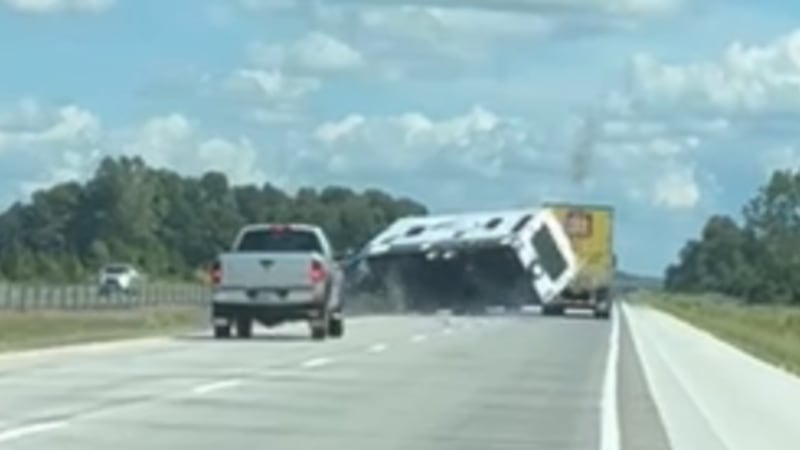 WATCH: Pickup truck towing camper rolls over on Ontario highway