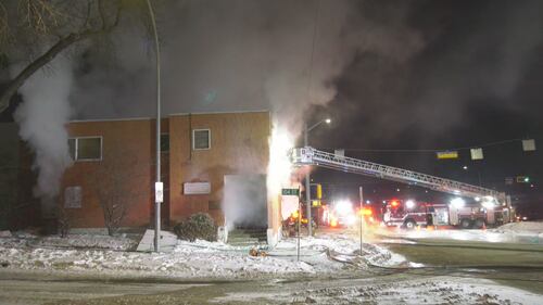 An Edmonton firefighter in a tower ladder bucket works at 10328 97 Ave. the morning of Feb. 23, 2026. (Evan Klippenstein / CTV News Edmonton)