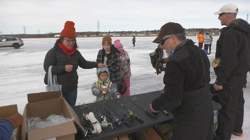 A family gears up to fish at Wabamun Lake at the Kids Can Catch event at Wabamun Lake, Alta., on Feb. 14, 2026. (Galen McDougall / CTV News Edmonton)
