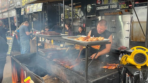 A man cooks ribs.