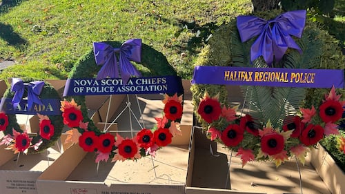 Three wreaths are pictured with purple ribbons.