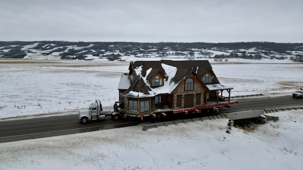 ‘A lot of emotion in there too’: Massive log home almost at its journey’s end