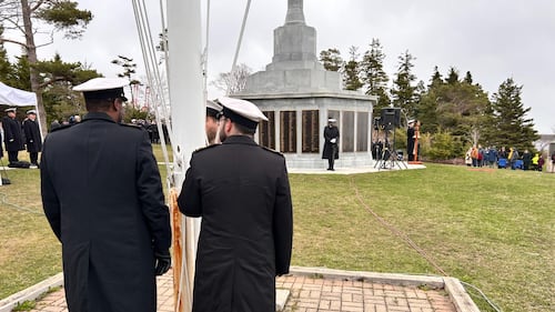 Two members of the Navy stand together.