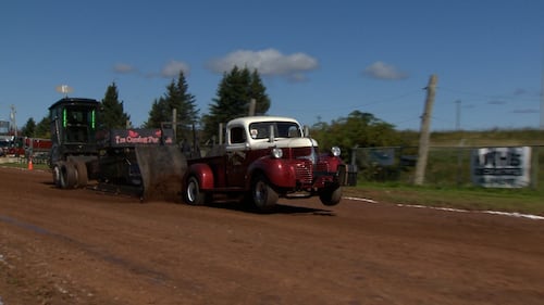 A truck pulls a tractor.