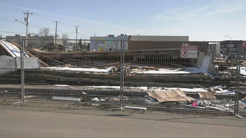 Piles of debris from a Feb. 19 fire at the Jasper Place Hotel sit on the lot on April 1, 2026. (Galen McDougall/CTV News Edmonton)
