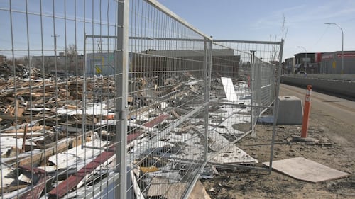 Piles of debris from a Feb. 19 fire at the Jasper Place Hotel sit inches from Stony Plain Road on April 1, 2026. (Galen McDougall/CTV News Edmonton)
