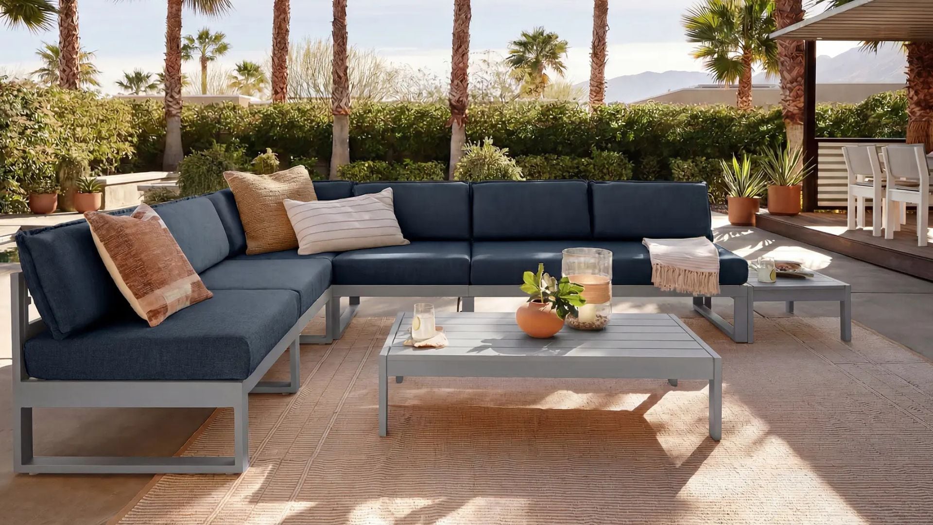 an outdoor sectional on a deck with palm trees