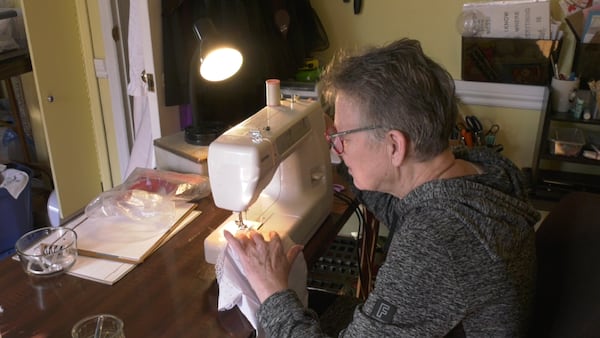 Retired Ont. palliative nurse sews upcycled gowns for infant loss