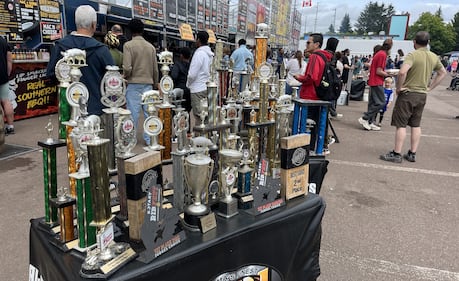 A table full of trophies are pictured.