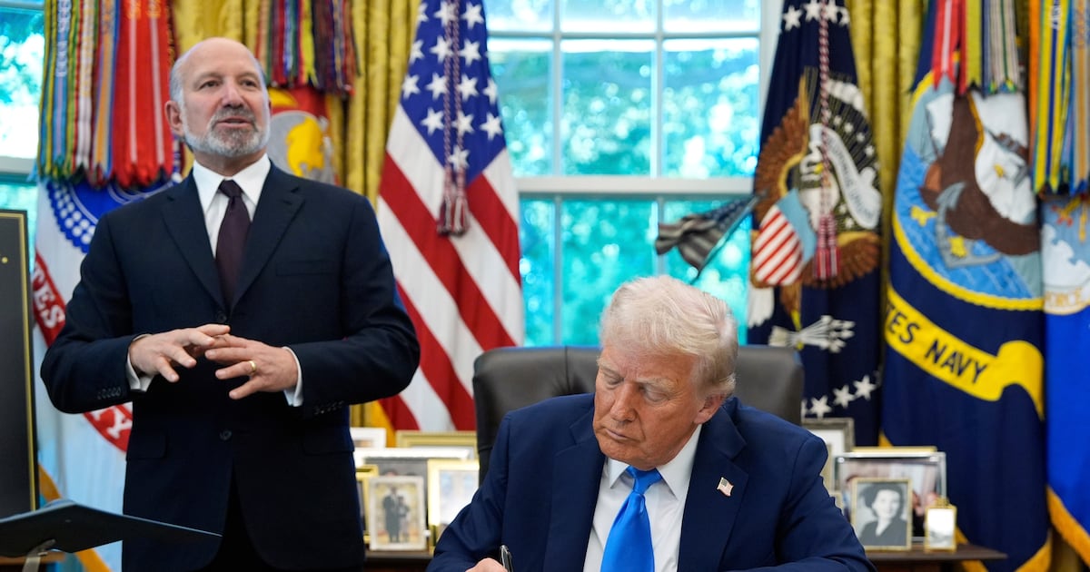 Commerce Secretary Howard Lutnick speaks as U.S. President Donald Trump signs the Gold Card executive order in the Oval Office of the White House in Washington on Sept. 19, 2025. (Alex Brandon / AP Photo)