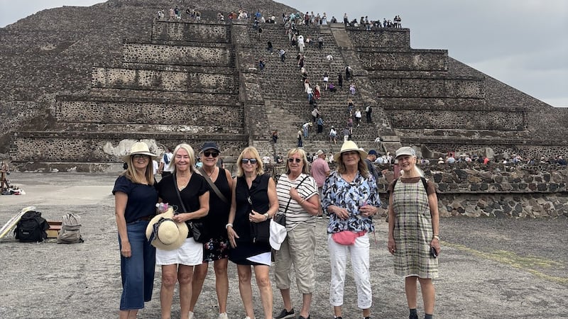B.C. tourists smile at Mexico pyramid. Behind them, a gunman, moments before killing