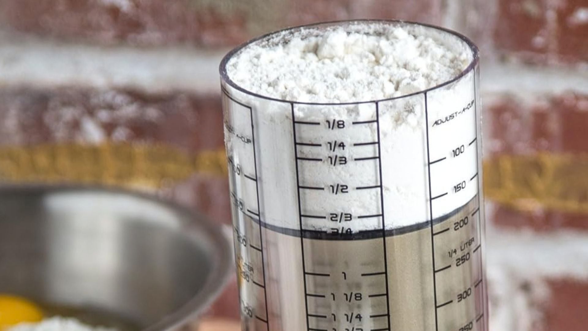 a kitchen measuring tool on a counter filled with flour