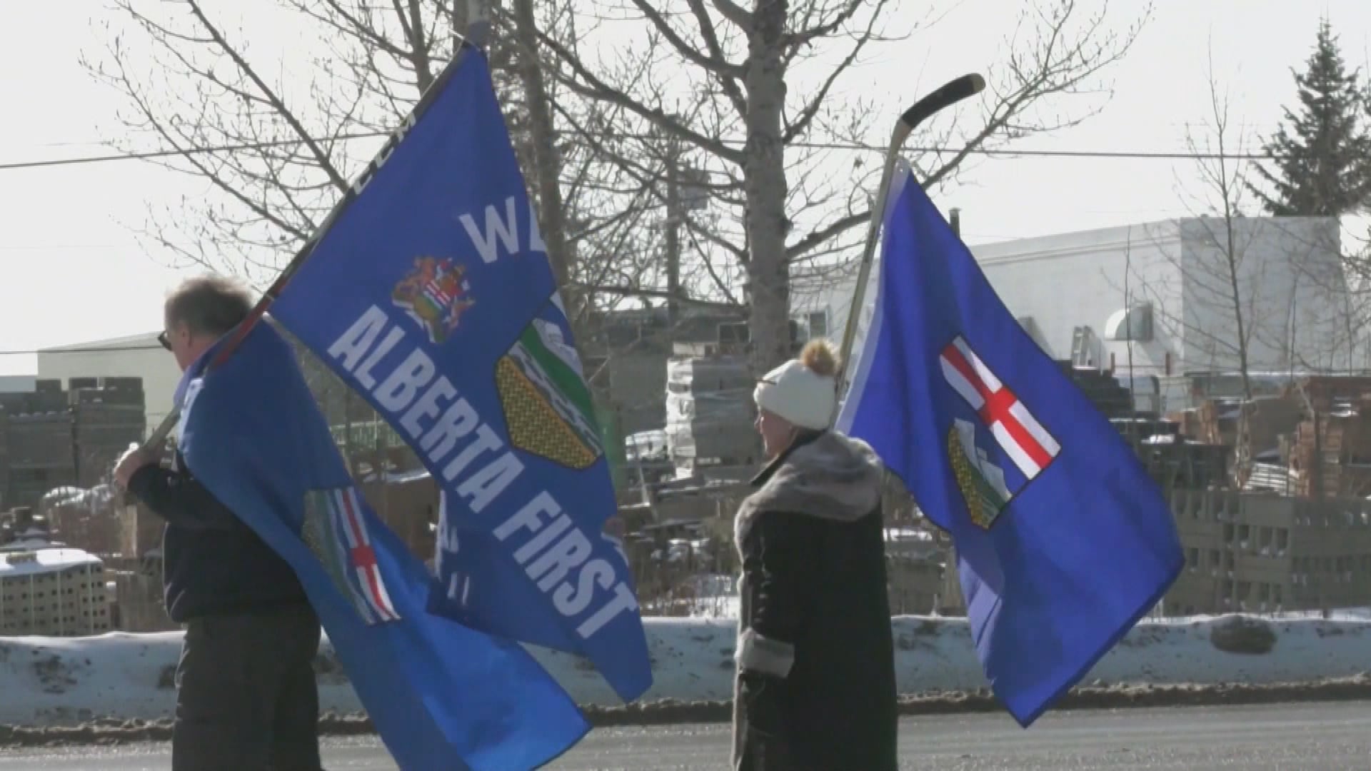 A man holds a flag that reads Alberta first. (CTV News Edmonton)