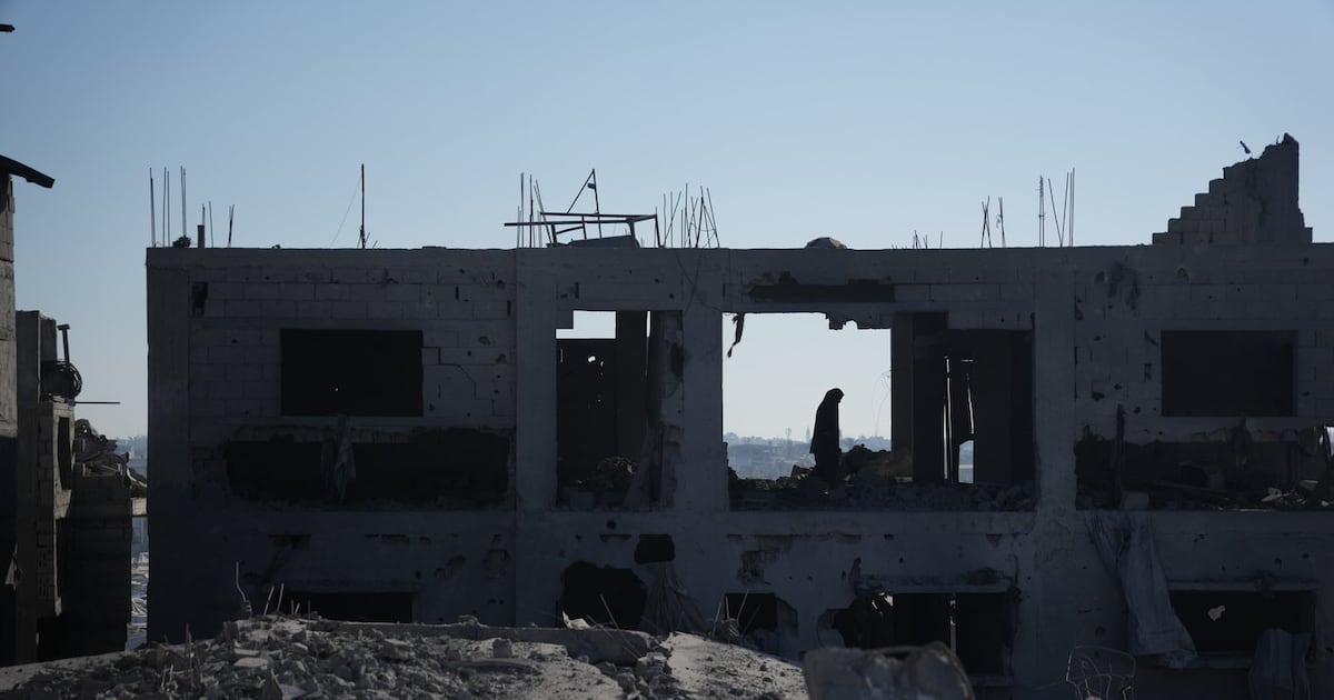 Photo: Ctvnews A Palestinian woman inspects a destroyed building following an Israeli airstrike in Deir al-Balah, central Gaza Strip