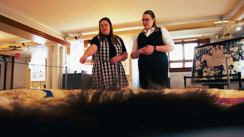 Fiona McTaggart and Meaghan Alyward from Lougheed House look at a map created on a buffalo hide – part of the ‘Mapping History: the Calgary Atlas Project’ exhibit.