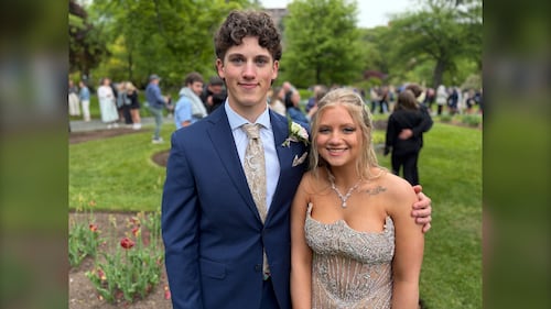 Two high school students pose together for prom.
