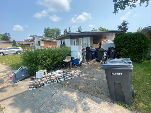 Laval residents say ‘hoarding’ neighbour turned front yard into dump