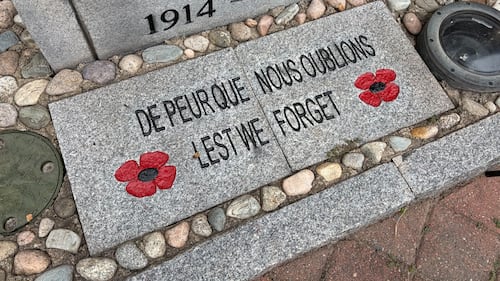 A plaque reading "Lest We Forget" is pictured.
