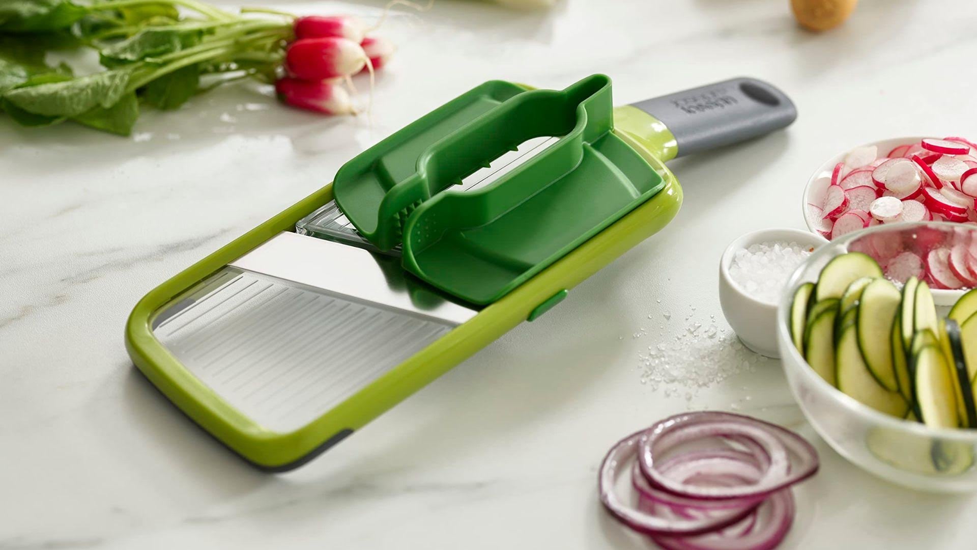 a slicer on a counter surrounded by sliced veggies