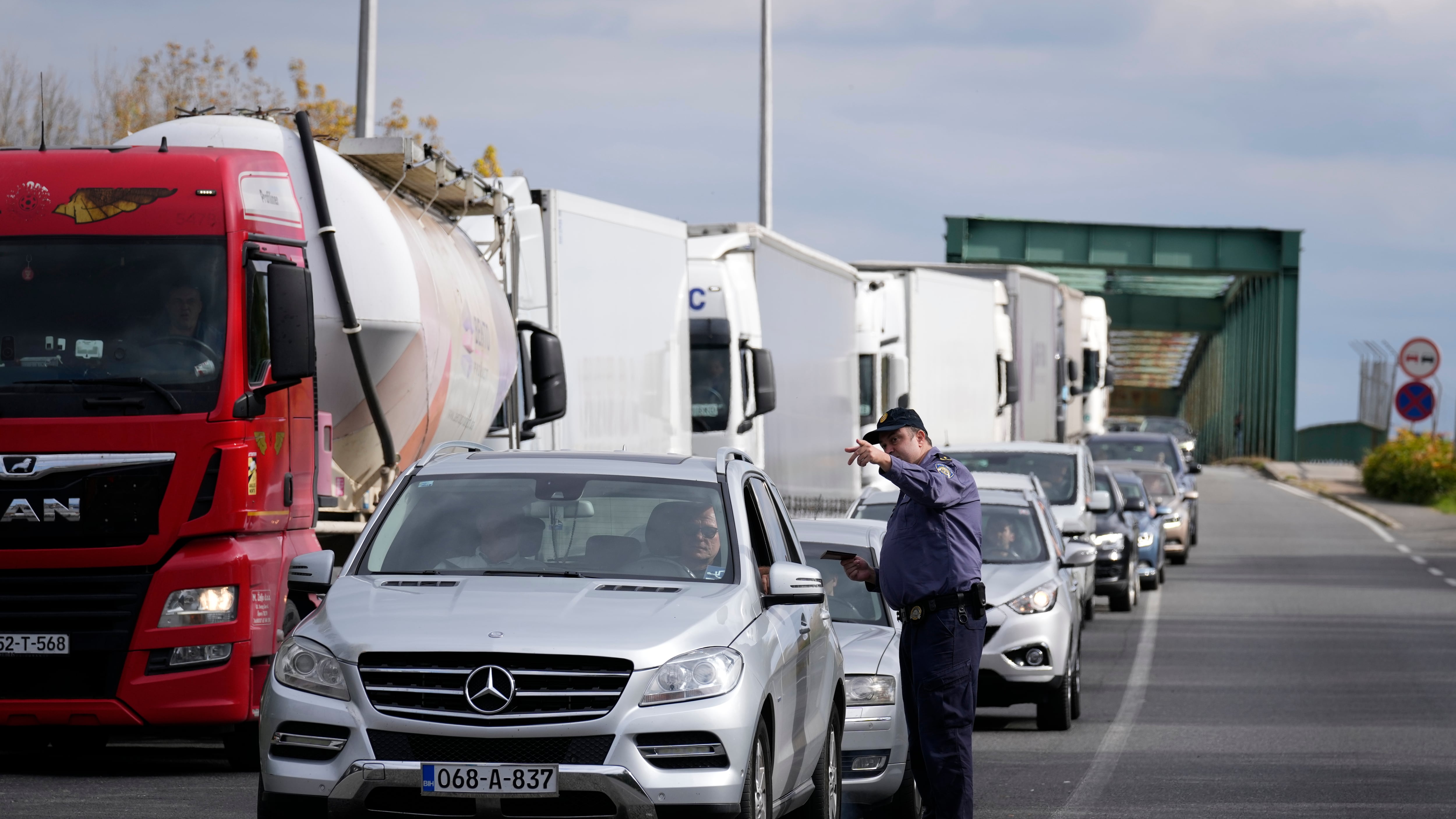 A police officer directs traffic at Stara Gradiska border crossing between Croatia and Bosnia and Herzegovina on Oct. 12, 2025, as the EU launched the new Entry/Exit System. (Darko Bandic / AP Photo)