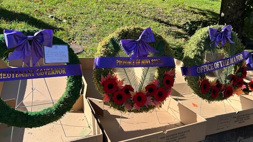 Three wreaths are pictured with purple ribbons.