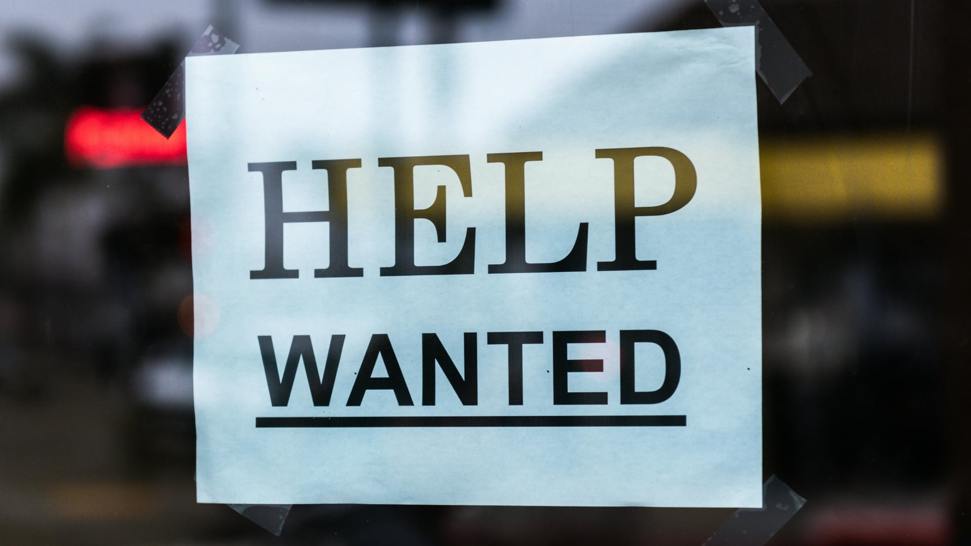 A stock photo of a 'help wanted' sign in a store window. (Pexels/Tim Mossholder)