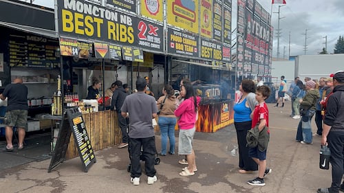 People stand in line waiting for ribs.