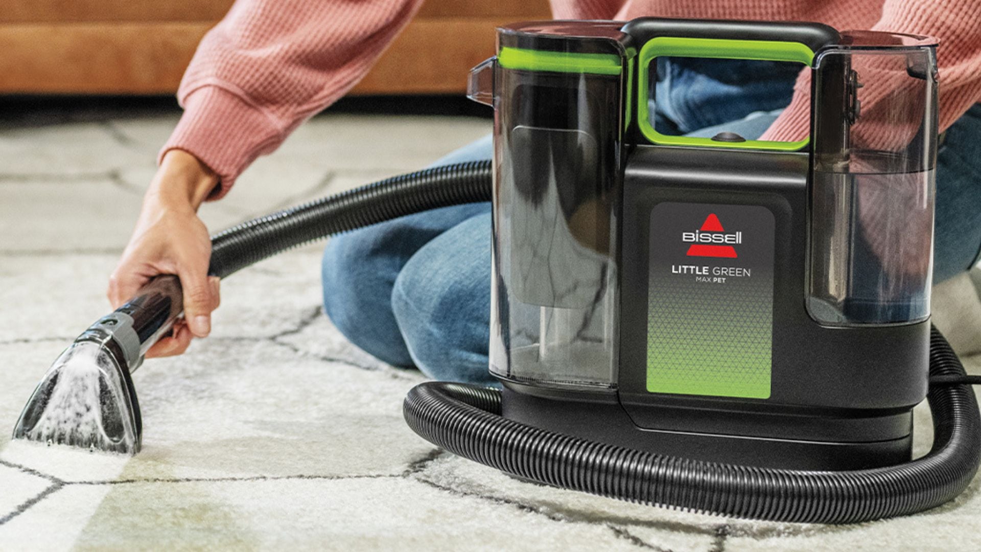 A person using a Bissell carpet cleaner.