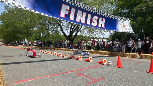 A blue finish line banner is pictured over a road.